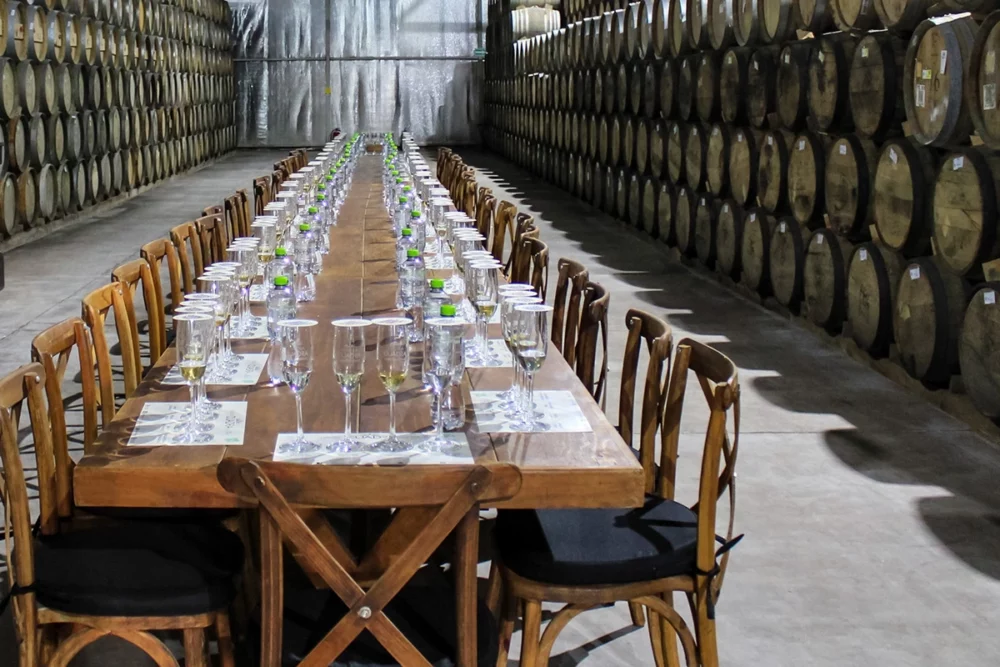 Giant table for tasting in barrel aging warehouse.